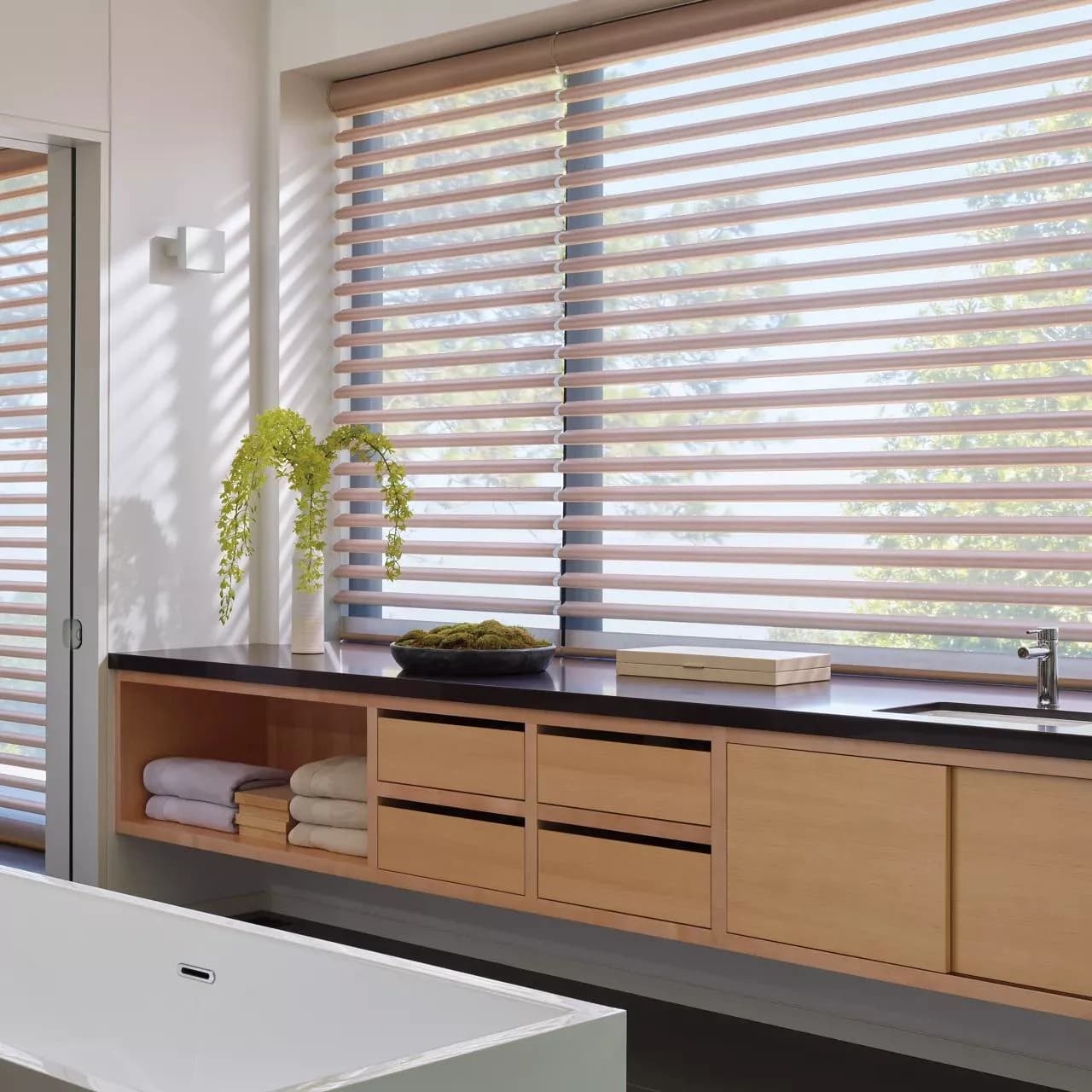 Motorized smart shades in Overland Park home with Alexa app on smartphone showing schedule automation